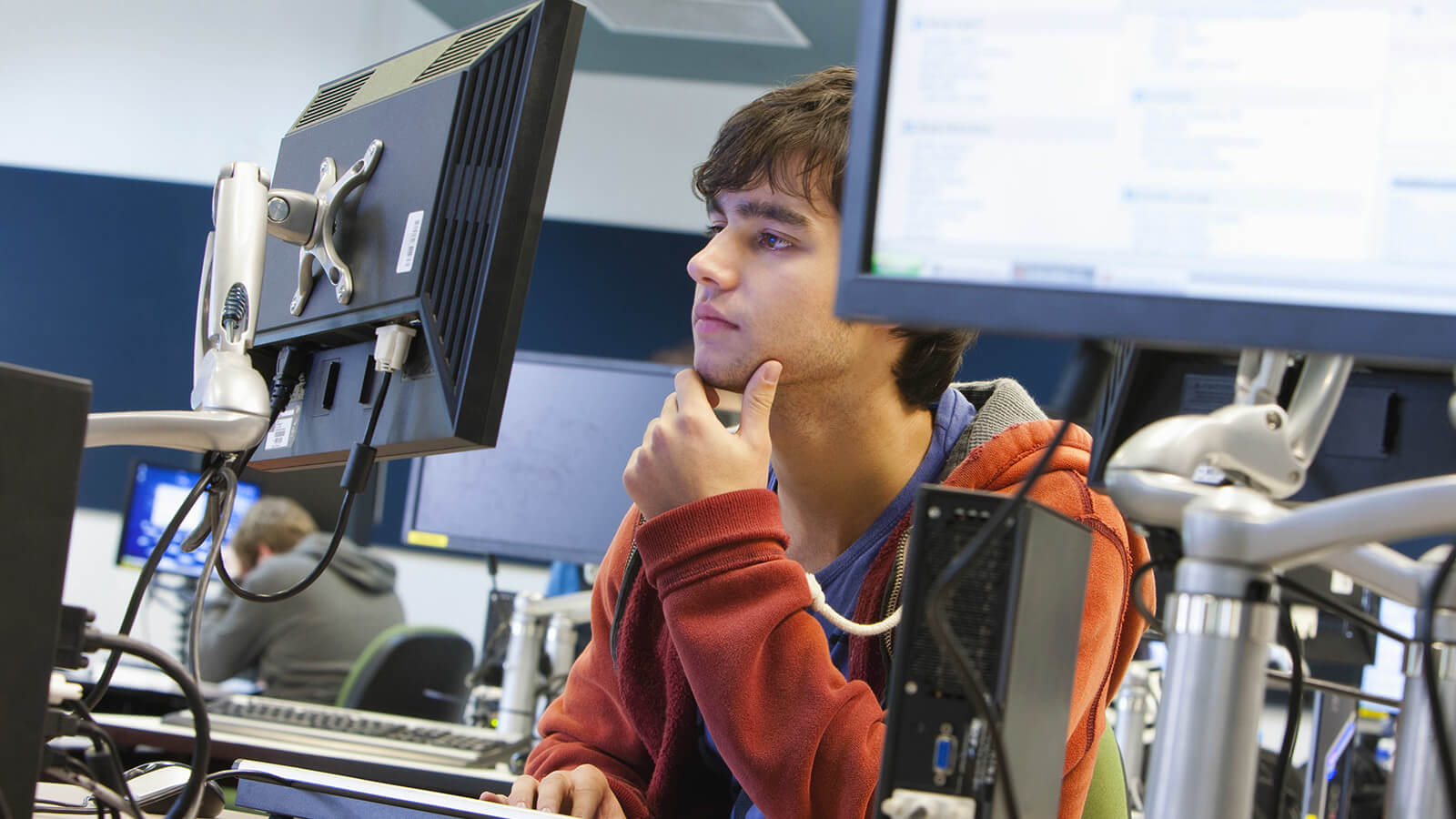 a student looks at a computer monitor deciding on a major