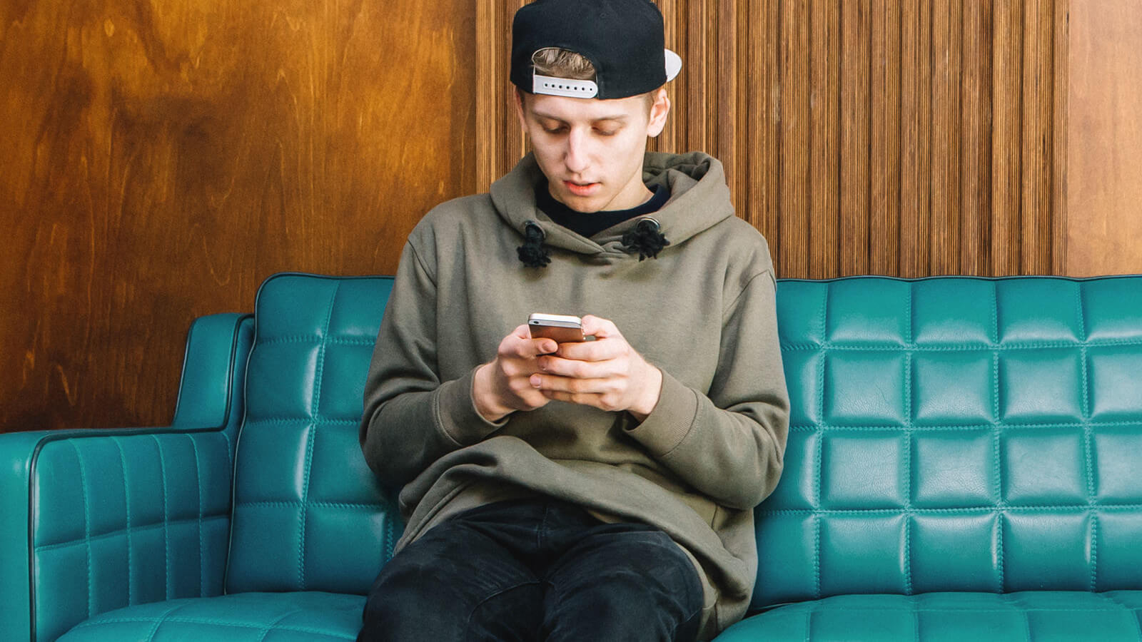 male student looking at test scores on his phone